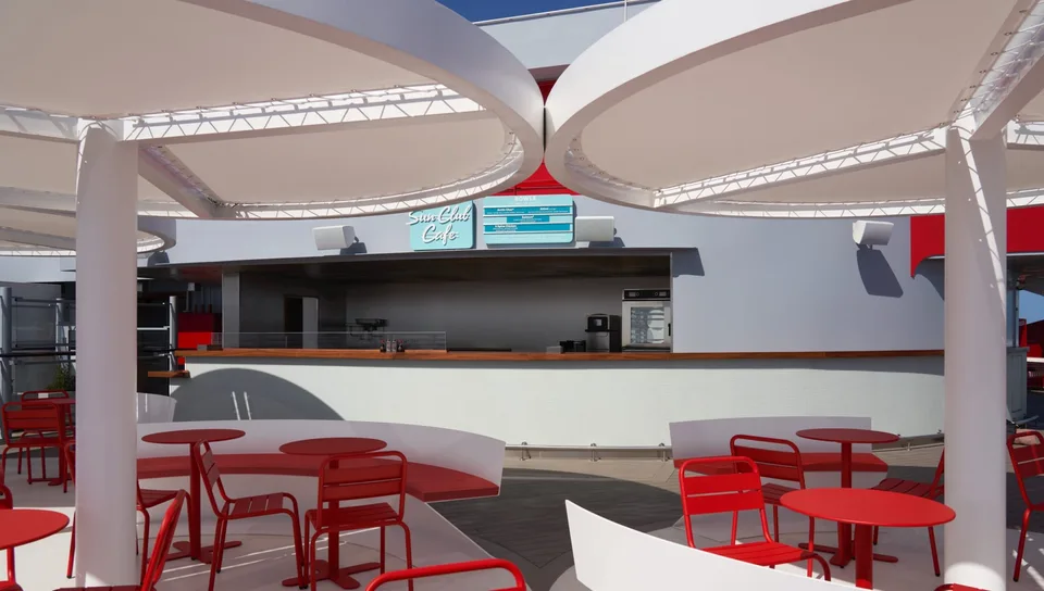 Outdoor seating area with red tables and chairs under a white curved canopy near the Seawise Café counter.