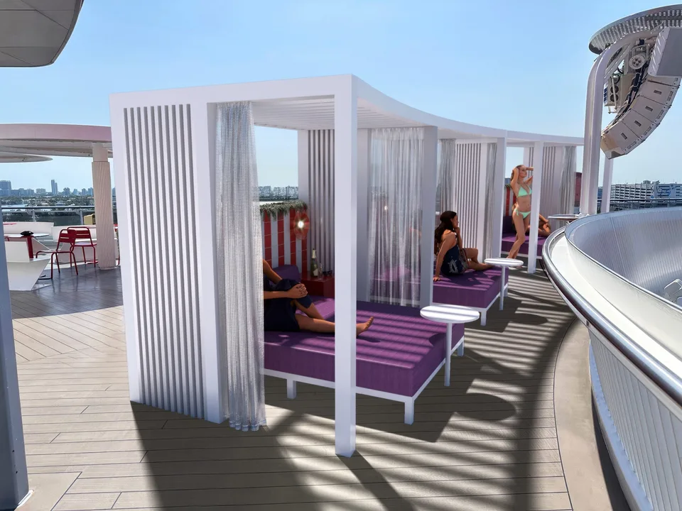 Aboard a cruise ship, three people relax on purple lounge beds under white canopy structures with sheer curtains.
