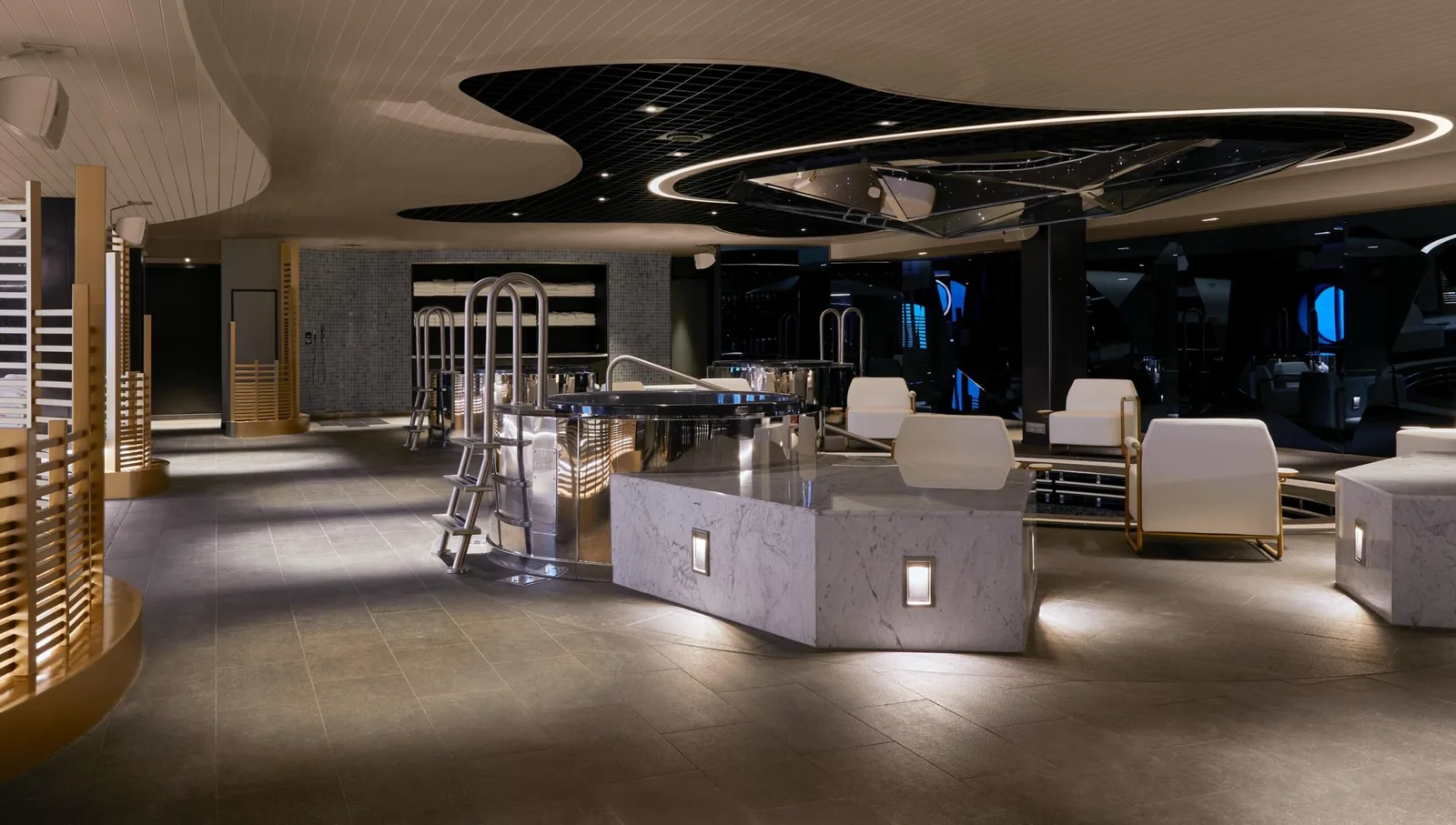 Interior view of a modern onboard spa area with a hot tub, sleek lighting, and tiled flooring.